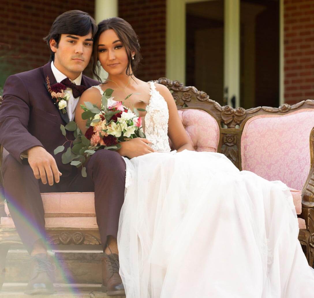 Сouple wearing a white gown and a black suit