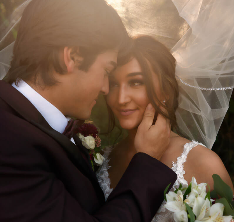 Сouple wearing a white gown and a black suit